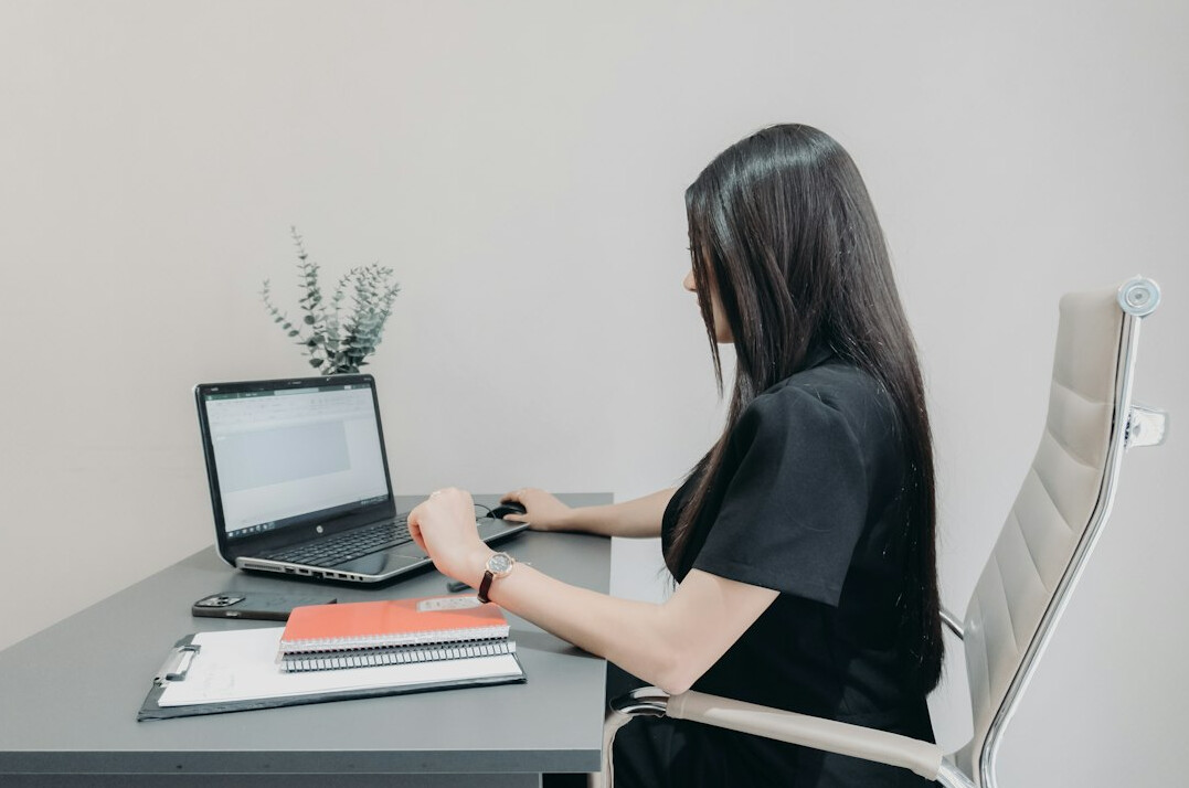 woman checking documents at desk